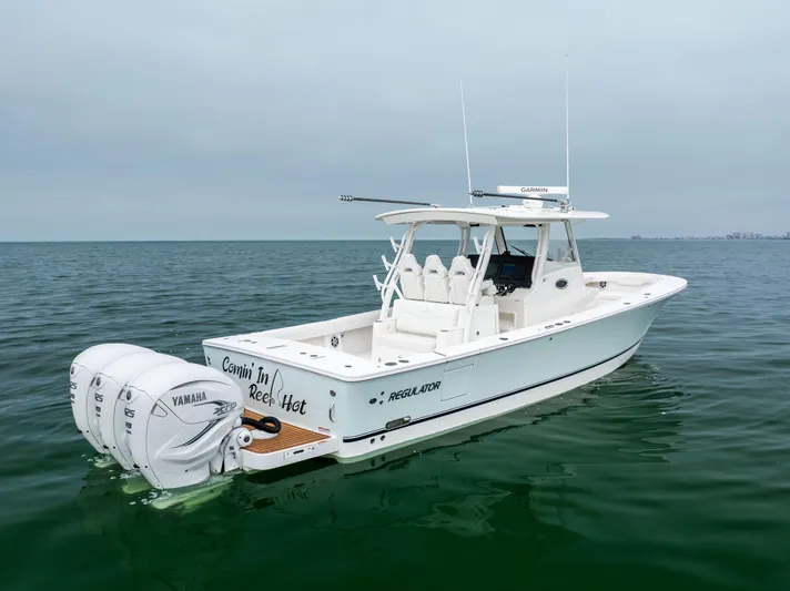 Comin In Reel Hot Yacht Photos Pics 2023 Regulator 37 boat on calm water, featuring twin Yamaha engines.