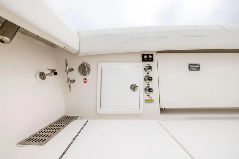 Comin In Reel Hot Yacht Photos Pics 2023 Regulator 37 boat interior with control panel and storage compartments.