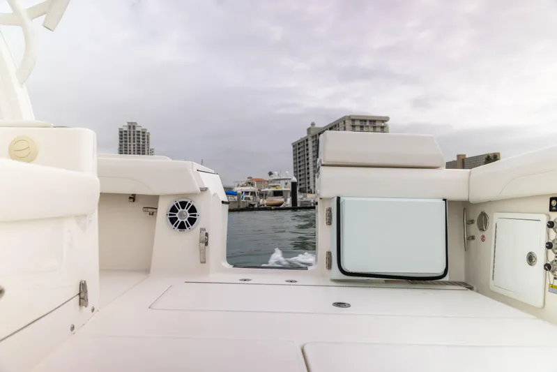 Comin In Reel Hot Yacht Photos Pics 2023 Regulator 37 boat interior with cityscape background, featuring sleek white design.