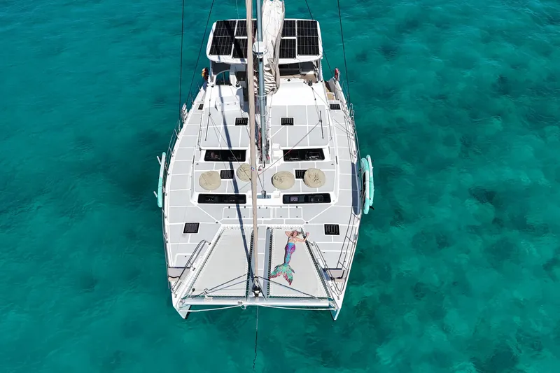 Tapas Yacht Photos Pics Aerial view of 2023 Royal Cape Catamarans 570 Flybridge on turquoise water.