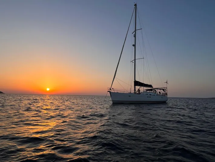  Yacht Photos Pics Sailboat Beneteau Oceanis 473 (2006) at sunset on calm sea.