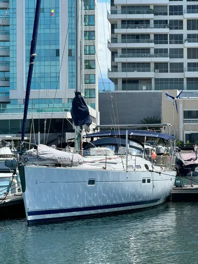  Yacht Photos Pics 2006 Beneteau Oceanis 473 yacht docked in a modern marina setting.