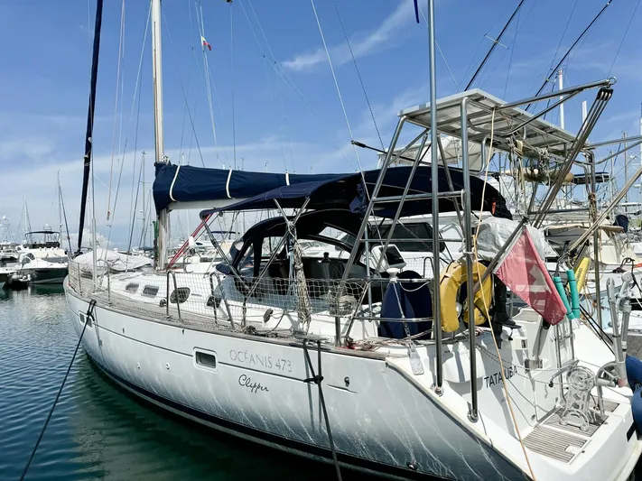  Yacht Photos Pics 2006 Beneteau Oceanis 473 sailboat docked in marina under clear blue sky.