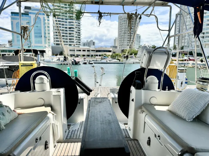  Yacht Photos Pics Beneteau Oceanis 473 sailboat interior, 2006 model, docked in a marina with cityscape view.