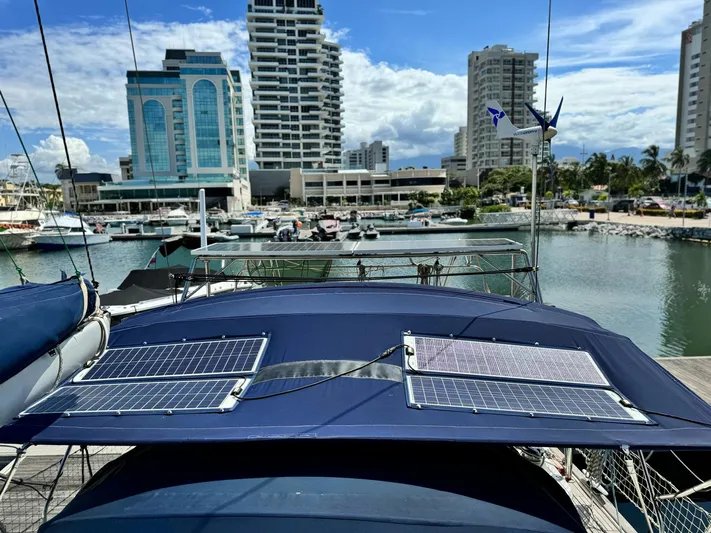  Yacht Photos Pics Beneteau Oceanis 473 sailboat with solar panels docked in a marina, 2006 model.