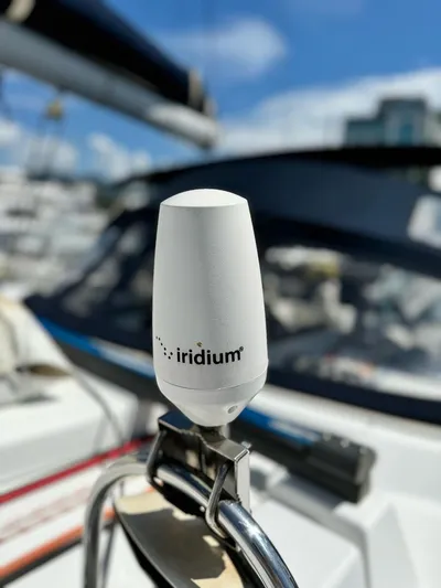 Yacht Photos Pics Iridium antenna on 2006 Beneteau Oceanis 473 sailboat, clear sky background.
