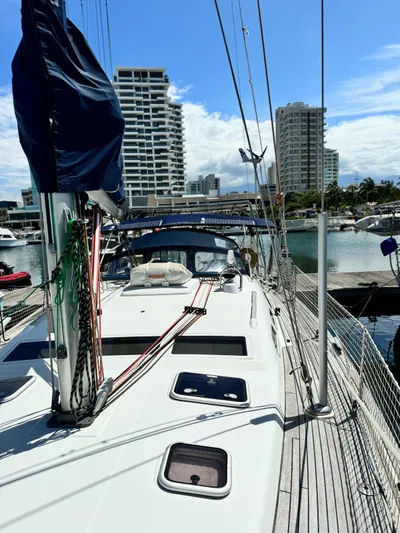  Yacht Photos Pics 2006 Beneteau Oceanis 473 sailboat docked in a marina with cityscape background.