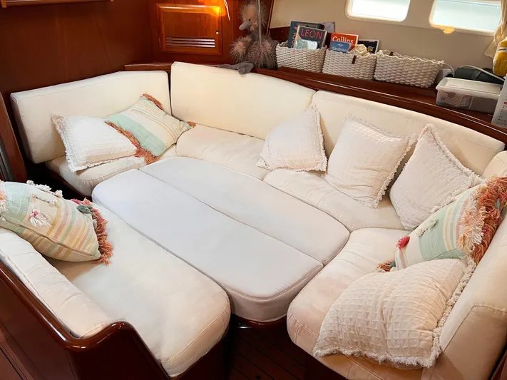  Yacht Photos Pics Luxurious interior of 2006 Beneteau Oceanis 473 sailboat with plush seating and cushions.
