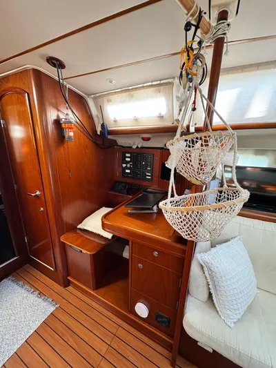  Yacht Photos Pics Interior of 2006 Beneteau Oceanis 473 sailboat with wooden finish and cozy seating area.