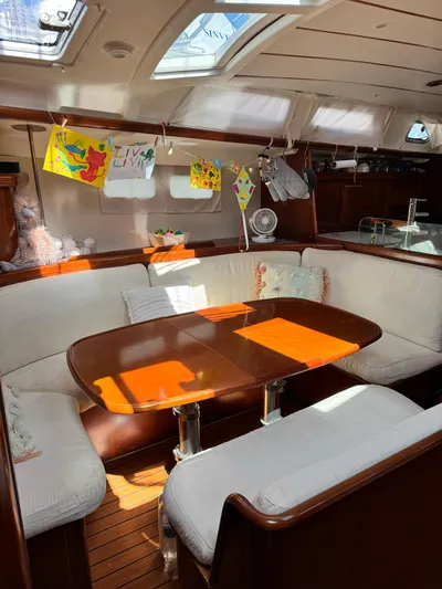  Yacht Photos Pics Interior of 2006 Beneteau Oceanis 473 sailboat with cozy seating and dining area.