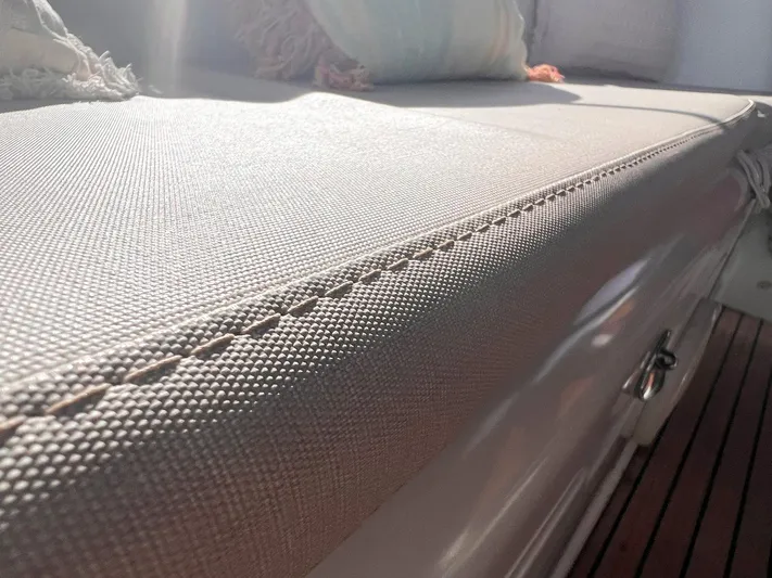  Yacht Photos Pics Cushioned seating on 2006 Beneteau Oceanis 473 yacht, showcasing detailed stitching and texture.