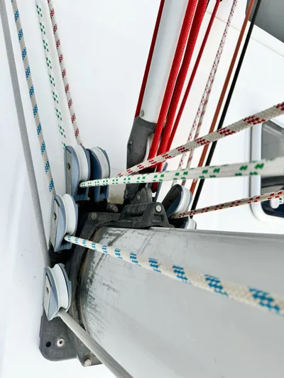  Yacht Photos Pics Close-up of rigging on a 2006 Beneteau Oceanis 473 sailboat, featuring colorful ropes and pulleys.