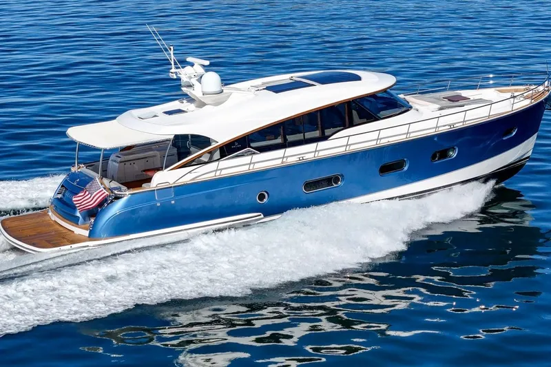 Valencia Yacht Photos Pics 2019 Belize 66 Sedan yacht cruising on open water, showcasing sleek design and luxury.
