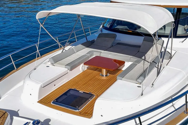 Valencia Yacht Photos Pics Luxurious 2019 Belize 66 Sedan yacht deck with cushioned seating and canopy.
