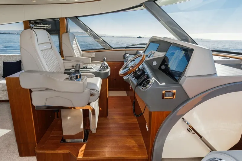 Valencia Yacht Photos Pics Luxurious interior of 2019 Belize 66 Sedan yacht with modern helm and leather seating.
