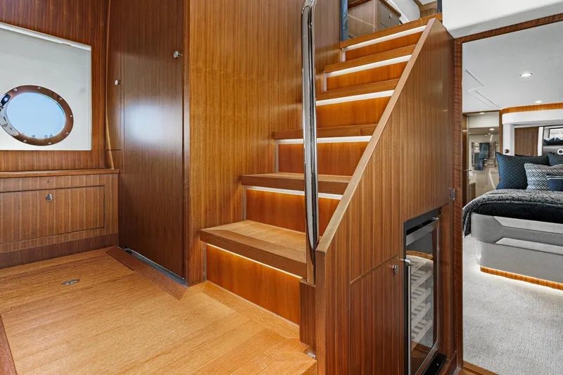 Valencia Yacht Photos Pics Luxurious interior of 2019 Belize 66 Sedan yacht with wooden stairs and modern design.