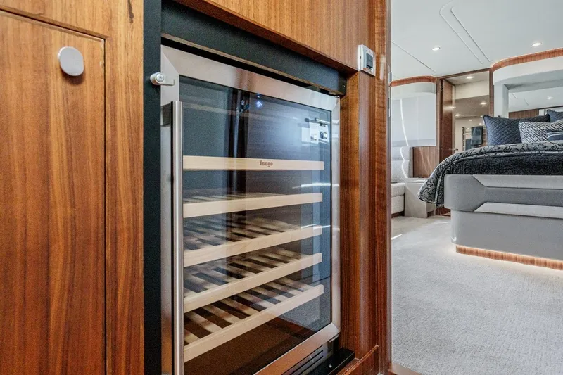 Valencia Yacht Photos Pics Luxurious interior of 2019 Belize 66 Sedan featuring a wine cooler and elegant bedroom.