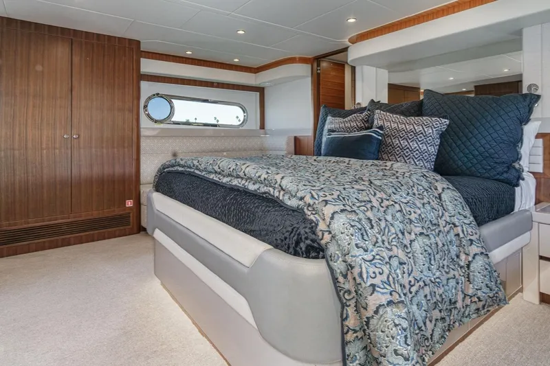 Valencia Yacht Photos Pics Luxurious bedroom interior of 2019 Belize 66 Sedan yacht with elegant bedding and wood accents.