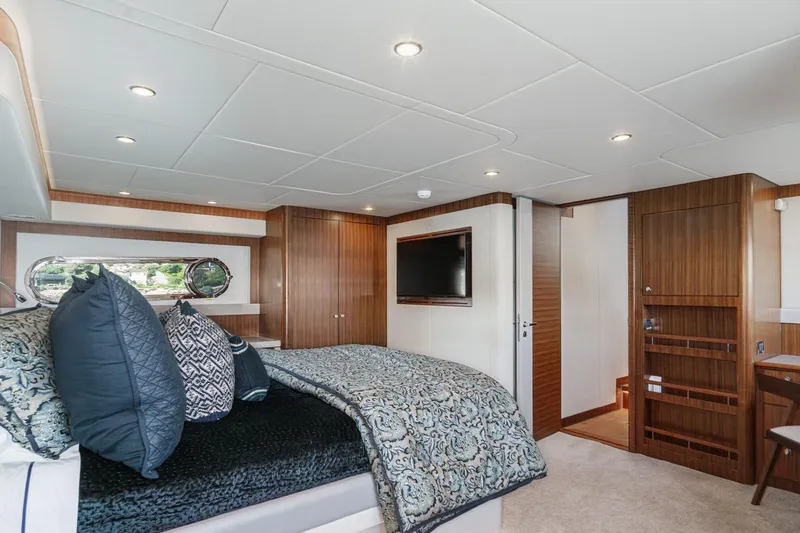 Valencia Yacht Photos Pics Luxurious bedroom interior of 2019 Belize 66 Sedan yacht with elegant wood paneling.