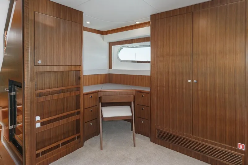 Valencia Yacht Photos Pics Luxurious wood-paneled interior of 2019 Belize 66 Sedan yacht with desk and storage.