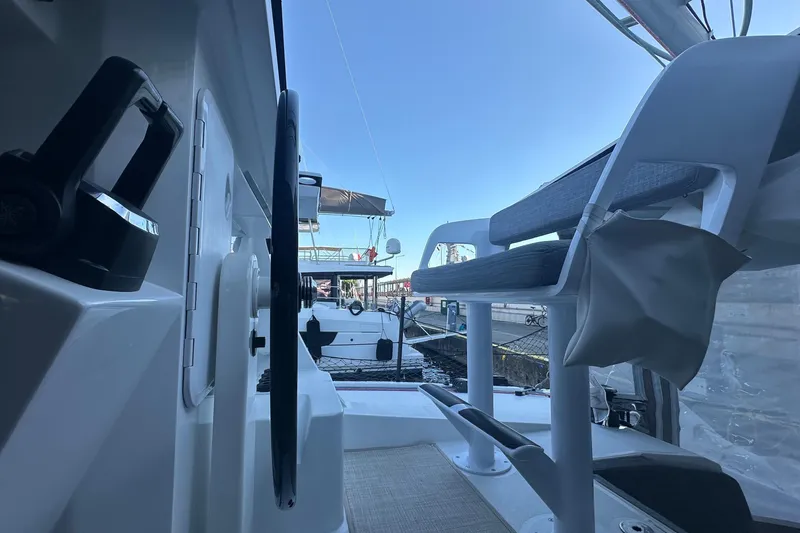 Gtfo Yacht Photos Pics 2023 Balance 482 yacht cockpit with steering wheel and seating, docked at marina.