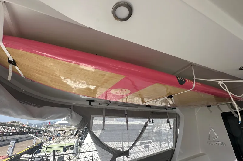Gtfo Yacht Photos Pics Pink and wood surfboard stored on a 2023 Balance 482 catamaran.