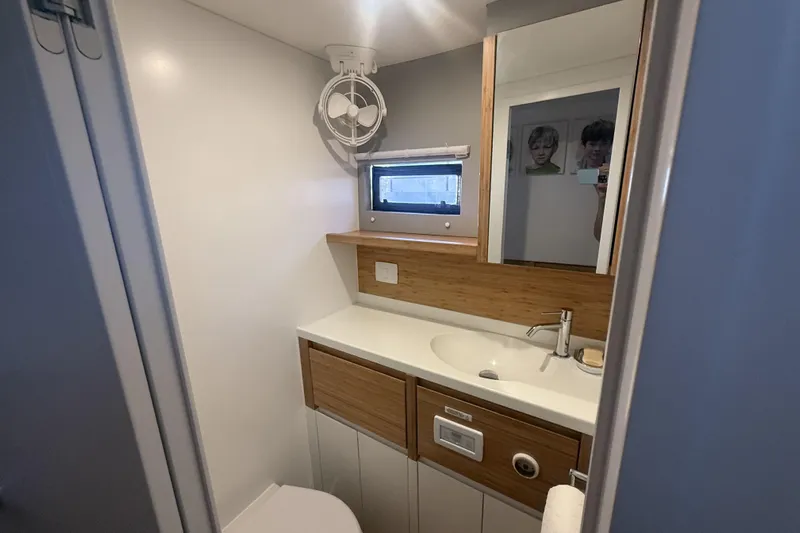 Gtfo Yacht Photos Pics Modern bathroom in Balance 482 yacht, featuring sleek design, wooden accents, and compact layout.