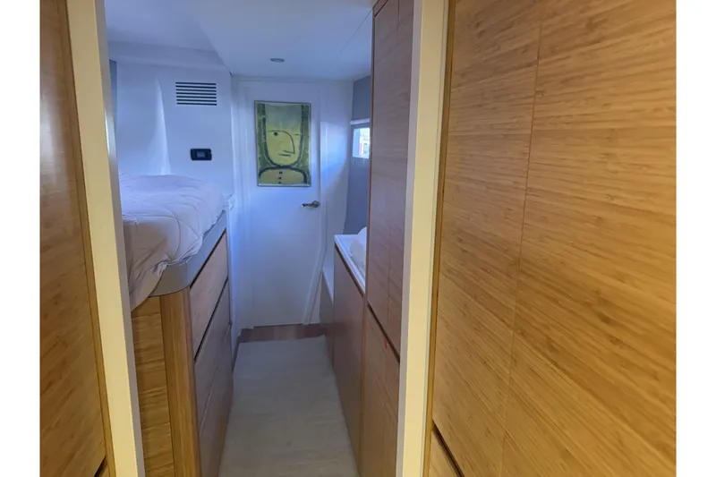 Gtfo Yacht Photos Pics Modern interior of Balance 482 yacht, featuring wooden cabinetry and a cozy sleeping area.