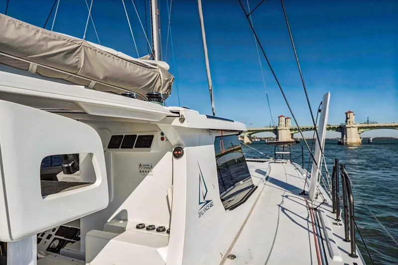 Gtfo Yacht Photos Pics 2024 Balance 482 yacht sailing near a bridge on a sunny day.