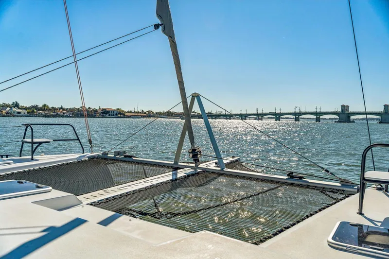 Gtfo Yacht Photos Pics 2024 Balance 482 catamaran on water with scenic bridge view.