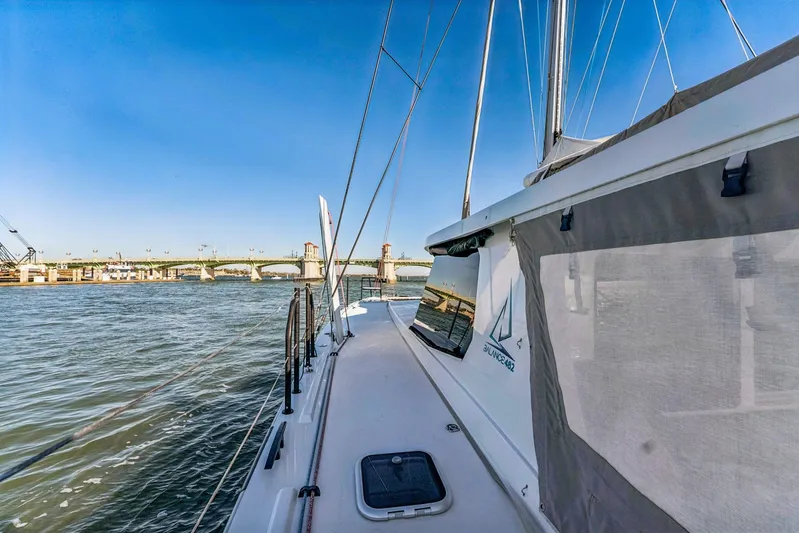 Gtfo Yacht Photos Pics Sailboat Balance 482, 2024 model, cruising near a bridge on a sunny day.