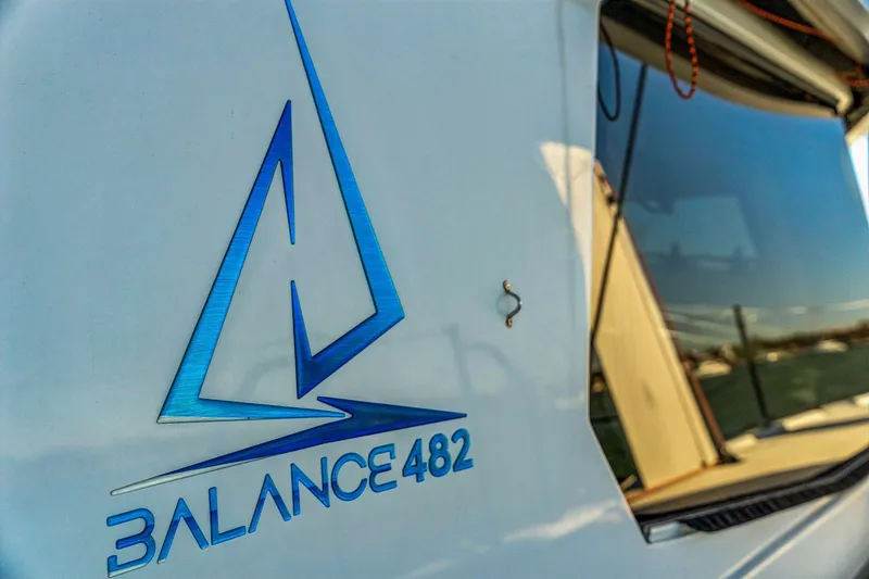 Gtfo Yacht Photos Pics 2024 Balance 482 yacht logo with sleek design and reflective window.