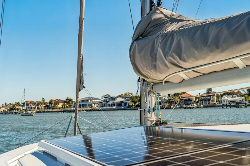 Gtfo Yacht Photos Pics Sailboat with solar panel on deck, Balance 482 model, 2024, near waterfront homes.