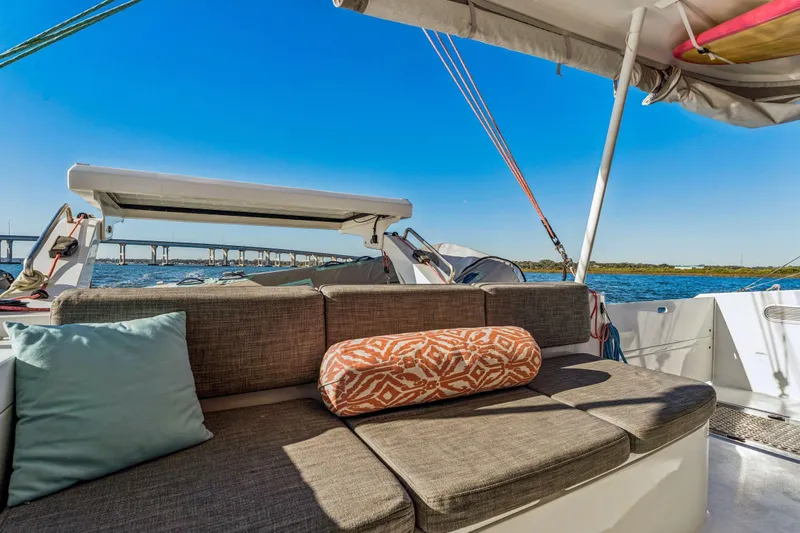Gtfo Yacht Photos Pics Luxurious seating on 2024 Balance 482 yacht with scenic ocean view and bridge in background.