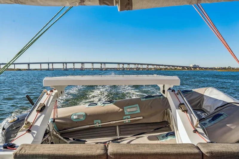 Gtfo Yacht Photos Pics 2024 Balance 482 boat cruising under a bridge on a sunny day.