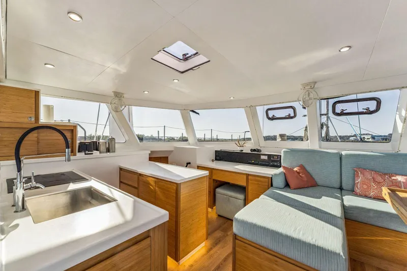 Gtfo Yacht Photos Pics Luxurious interior of 2024 Balance 482 yacht with modern kitchen and cozy seating area.