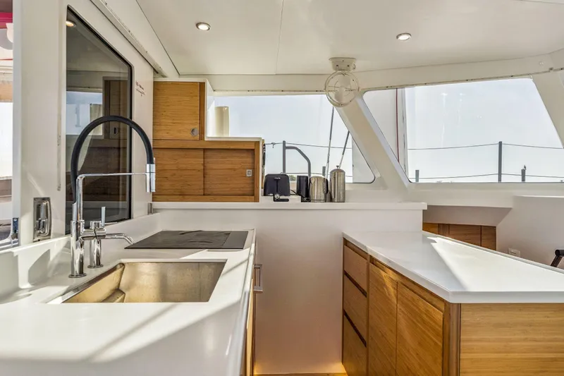 Gtfo Yacht Photos Pics Modern kitchen interior on 2024 Balance 482 yacht, featuring sleek countertops and wooden cabinetry.