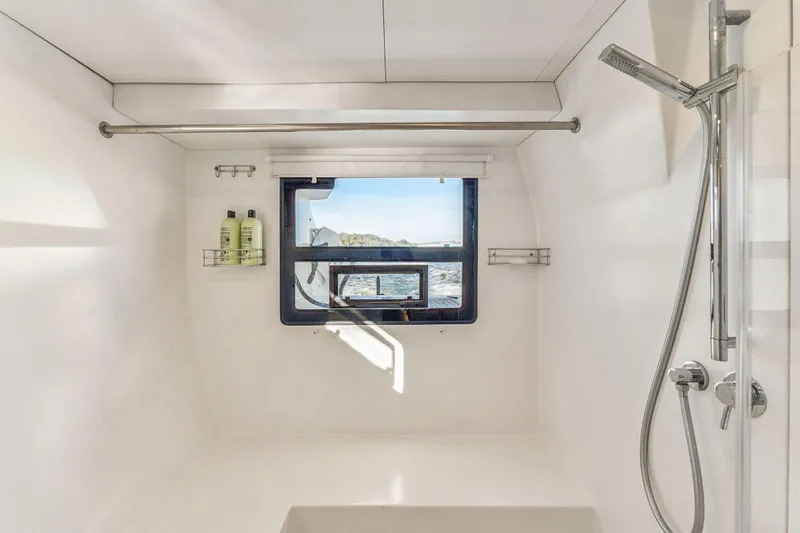 Gtfo Yacht Photos Pics Modern yacht bathroom with ocean view, featuring a sleek shower and minimalist design. Balance 482, 2024.