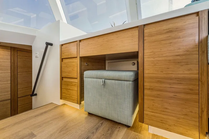 Gtfo Yacht Photos Pics Modern interior with wooden cabinets and a cushioned ottoman, Balance 482, 2024 model.