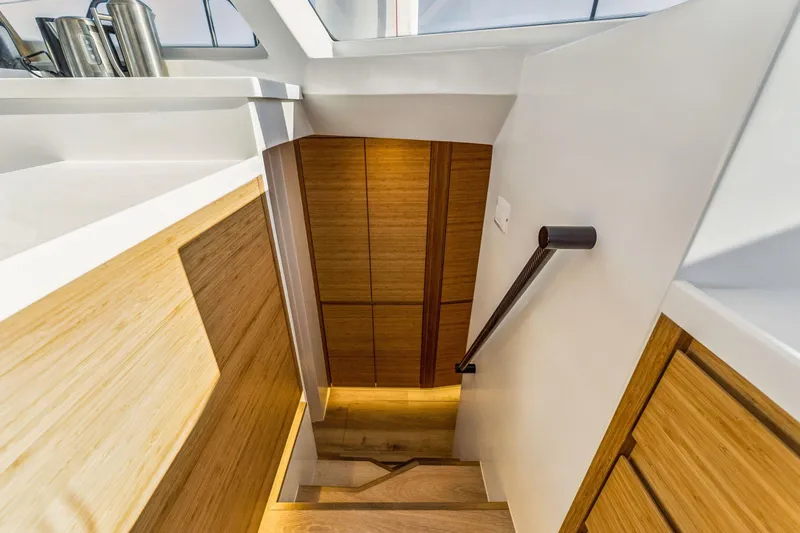 Gtfo Yacht Photos Pics Modern interior staircase on Balance 482 yacht, 2024 model, featuring sleek wood and white design.