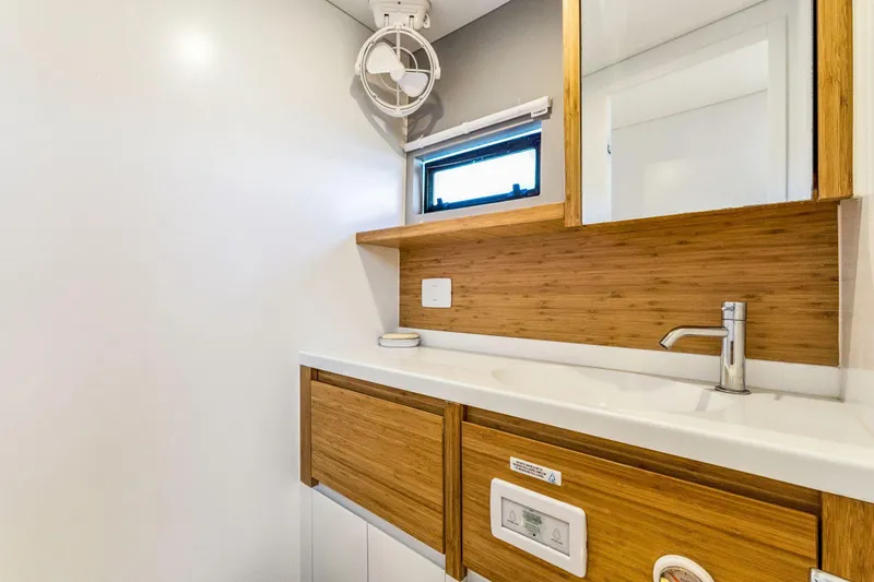 Gtfo Yacht Photos Pics Modern bathroom in 2024 Balance 482 model, featuring wooden cabinetry and sleek fixtures.