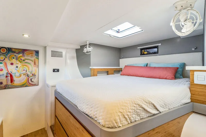 Gtfo Yacht Photos Pics Modern bedroom interior in 2024 Balance 482 yacht, featuring colorful artwork and skylight.