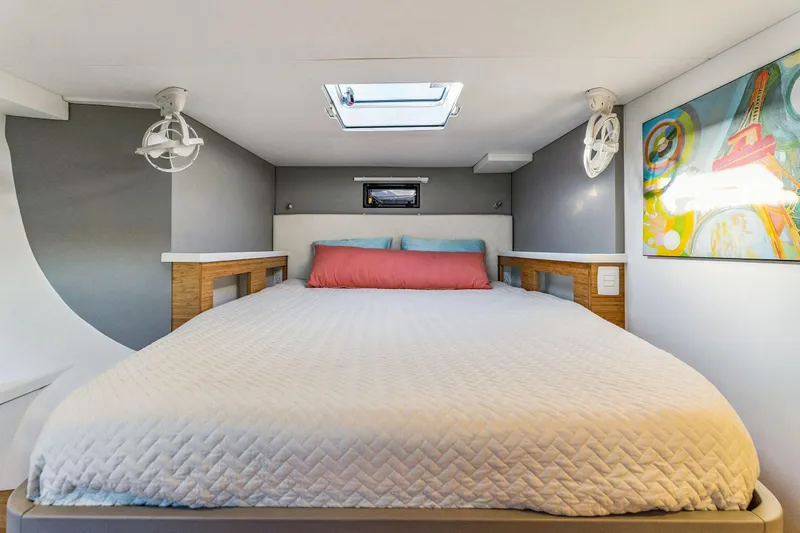 Gtfo Yacht Photos Pics Modern bedroom interior in 2024 Balance 482, featuring skylight and colorful artwork.