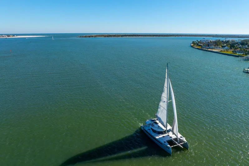 Gtfo Yacht Photos Pics Sailing catamaran Balance 482, 2024 model, gliding on serene blue waters under clear skies.