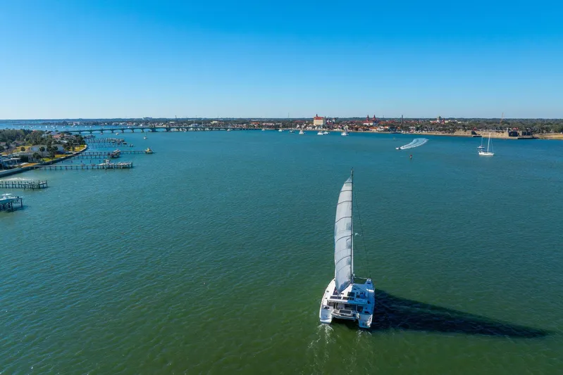 Gtfo Yacht Photos Pics Sailing catamaran Balance 482, 2024 model, cruising on a sunny day near a coastal city.