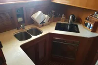 Compact kitchen in 2001 Trader 535 Signature yacht with dual sinks and electric stove.