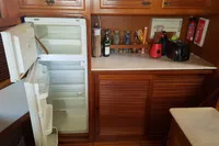 Kitchen area of a 2001 Trader 535 Signature yacht with open fridge and countertop appliances.
