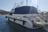 Luxury 2001 Trader 535 Signature yacht docked in a marina, featuring a sleek design.