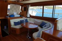 Luxurious interior of 2001 Trader 535 Signature yacht with curved seating and ocean view.