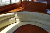 Interior of 2001 Trader 535 Signature yacht with curved seating and wooden table.
